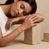 women wearing of an 18ct gold plated chunky puffy wave link bracelet with lobster clasp 