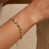 A close-up of an 18ct gold plated chunky puffy wave link bracelet with lobster clasp 